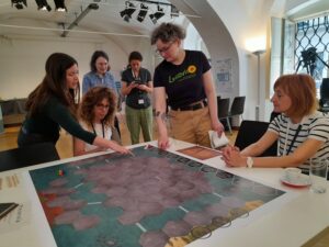 People around a table playing a board game on digital archiving for citizens. 